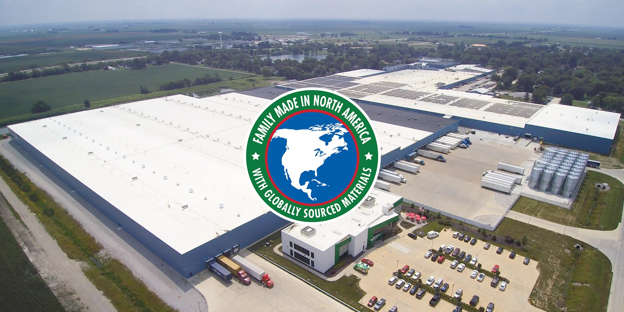 Graphic of North America overlaid on image of large factory building