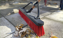 Push broom sweeping up leaves