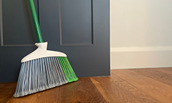 Broom sitting on wood floor