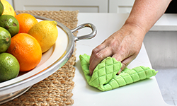 Person wiping down countertop