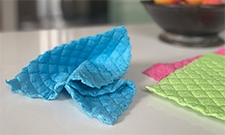 Blue, green, and pink cloths on a countertop